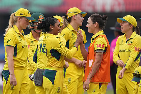 Australia's Alana King, center, celebrates with teammate the wicket of South Africa's Annerie Dercksen during the ICC Women's Cricket World Cup match between Australia and South Africa in Indore.