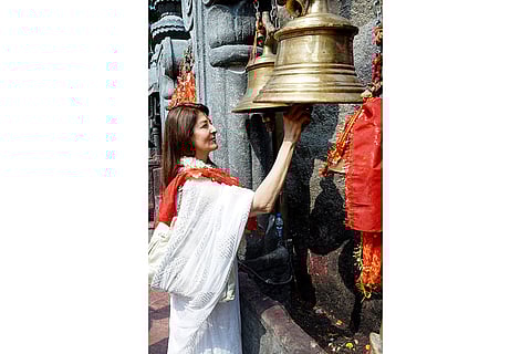 Former Bollywood actor Sangeeta Bijlani rings the temple bell during her visit to offer prayers at Kamakhya Temple, in Guwahati, Assam.