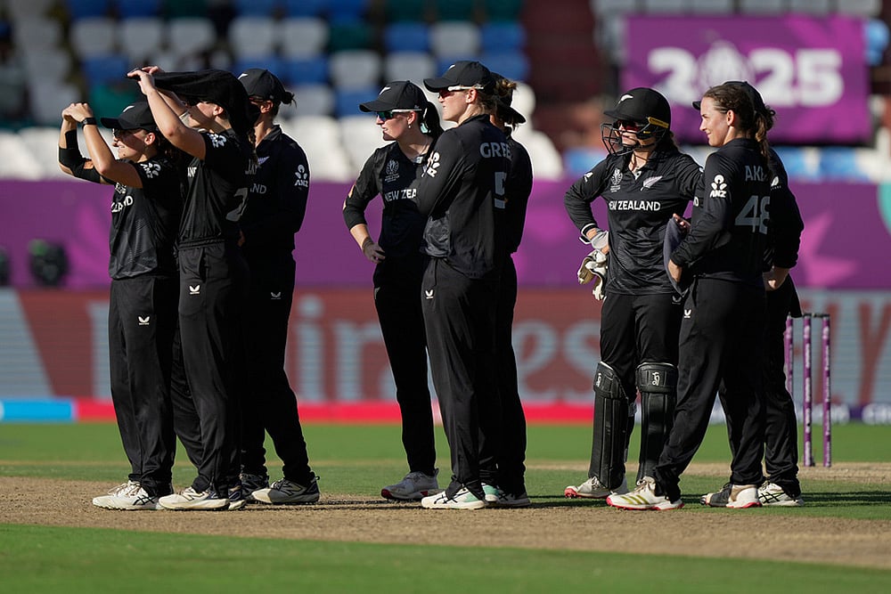New Zealand's players wait for the third umpire's review for the wicket of England's Amy Jones during the ICC Women's Cricket World Cup match between England and New Zealand at ACA–VDCA Cricket Stadium in Visakhapatnam. - | Photo: AP/Mahesh Kumar A.
