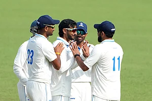 | Photo: PTI/Swapan Mahapatra : Bengal's Shahbaz Ahmed celebrates with teammates after dismissing Gujarat's Chintan Gaja on Day 3 of the Ranji Trophy match at Eden Gardens, Kolkata.