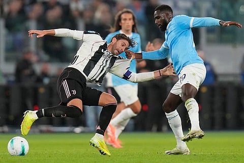 Juventus' Manuel Locatelli, left, and Lazio's Boulaye Dia fight for the ball during the Italian Serie A soccer match between Lazio and Juventus in Rome.