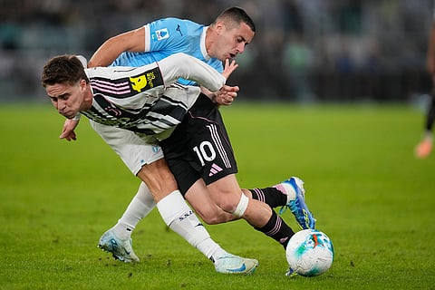 Lazio's Adam Marusic tackles Juventus' Kenan Yildiz during the Italian Serie A soccer match between Lazio and Juventus in Rome.