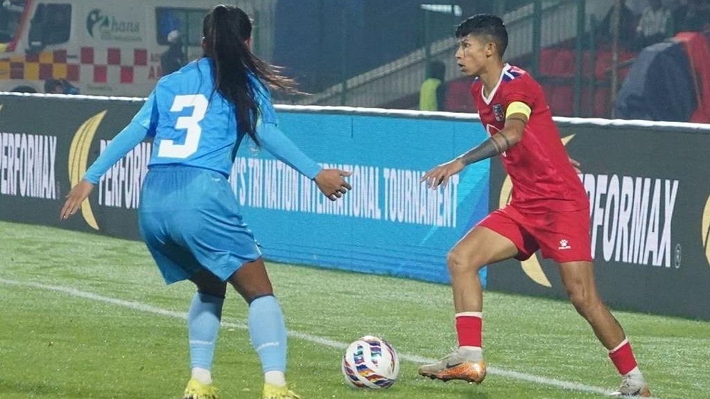 | Photo: X/DSYA_Meghalaya : Nepal's Sabitra Bhandari and India's Nirmala Devi Phanjoubam fight for the ball during the Tri-Nation Women's International Friendly match at the Jawaharlal Nehru Stadium, Shillong, on October 27, 2025.