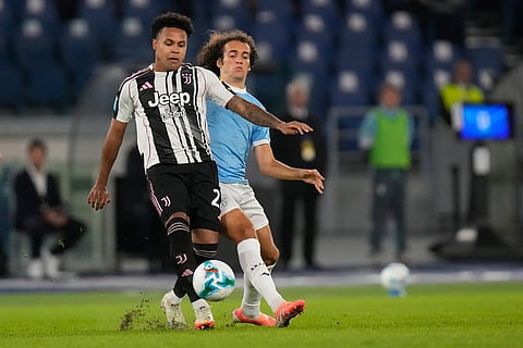 Juventus' Weston McKennie passes the ball by Lazio's Matteo Guendouzi during the Italian Serie A soccer match between Lazio and Juventus in Rome.
