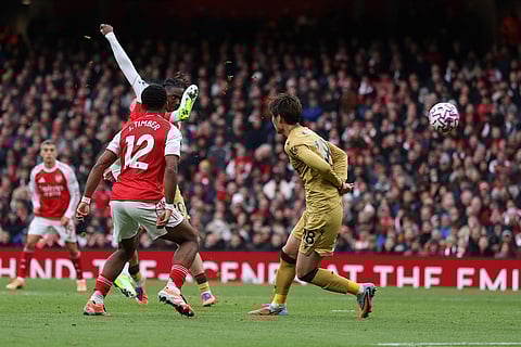 Arsenal's Eberechi Eze, centre, scores his side's opening goal during the English Premier League soccer match between Arsenal and Crystal Palace in London.