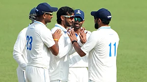 Photo: PTI : Bengal's Shahbaz Ahmed celebrates with teammates after dismissing Gujarat's Chintan Gaja on Day 3 of the Ranji Trophy match at Eden Gardens.