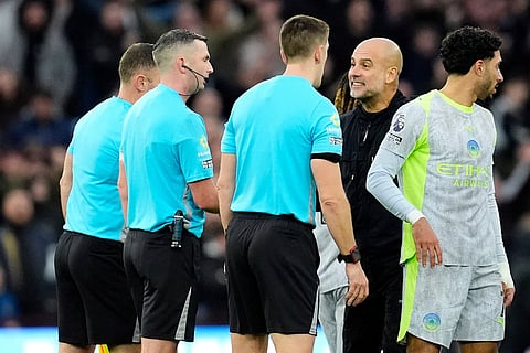 Manchester City manager Pep Guardiola (second right) speaks with referee Michael Oliver following defeat the English Premier League match between Aston Villa and Manchester City, in Birmingham, England.