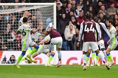 Aston Villa's Matty Cash, right, scores his side's first goal during the English Premier League match between Aston Villa and Manchester City, in Birmingham, England.