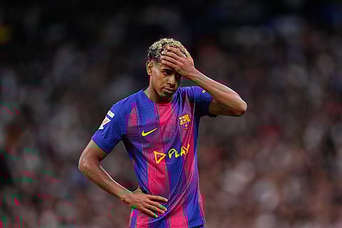 Barcelona's Lamine Yamal gestures during the Spanish La Liga soccer match between Real Madrid and Barcelona, in Madrid.