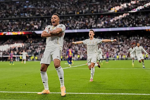 Real Madrid's Kylian Mbappe reacts after scoring during a La Liga soccer match between Real Madrid and Barcelona in Madrid, Spain.

