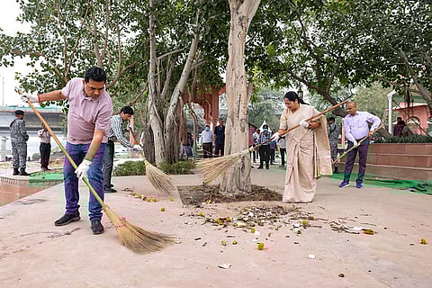 In this image posted on Oct. 28, 2025, Delhi Chief Minister Rekha Gupta with cabinet minister Kapil Mishra takes part in a cleanliness drive at Vasudev Ghat after the conclusion of the 'Chhath Puja' festival, in New Delhi.