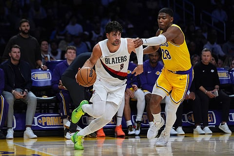 Portland Trail Blazers forward Deni Avdija (8) drives the ball against Los Angeles Lakers forward Rui Hachimura (28) during the second half of an NBA basketball game in Los Angeles.