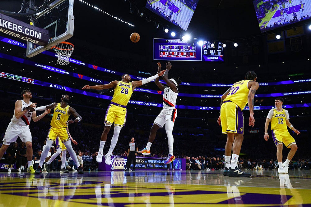 | Photo: AP/Ethan Swope : Los Angeles Lakers forward Rui Hachimura (28) blocks the ball against Portland Trail Blazers guard Jrue Holiday (5) during the second half of an NBA basketball game in Los Angeles.