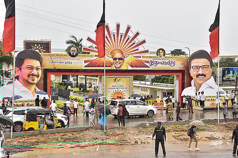 Commuters pass by the venue of the party's training session titled 'My Polling Booth, Winning Booth', at Mamallapuram in Chengalpattu district, Tamil Nadu.
