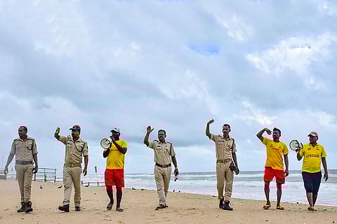 Security personnel and life guards patrol at a beach and urge visitors not to venture too deep into the sea in view of Cyclone 'Montha', in Puri, Odisha.