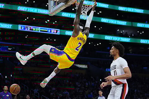 Los Angeles Lakers forward Jarred Vanderbilt (2) dunks the ball during the first half of an NBA basketball game in Los Angeles.