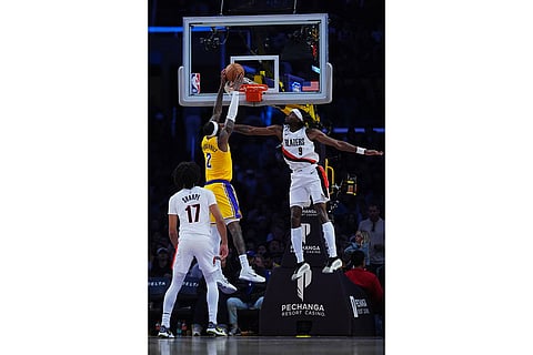 Los Angeles Lakers forward Jarred Vanderbilt (2) dunks the ball against the Portland Trail Blazers during the second half of an NBA basketball game in Los Angeles.