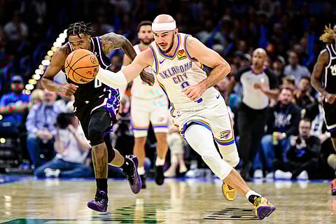 Oklahoma City Thunder guard Alex Caruso drives the ball during the second half of an NBA basketball game against Sacramento Kings in Oklahoma City. 