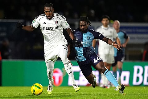 Fulham's Issa Diop, left, and Wycombe Wanderers' Fred Onyedinma battle for the ball during the English League Cup fourth round soccer match between Wycombe Wanderers and Fulham, in High Wycombe, England.