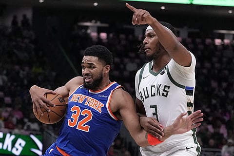 New York Knicks' Karl-Anthony Towns tries to get past Milwaukee Bucks' Myles Turner during the first half of an NBA basketball game in Milwaukee. 

