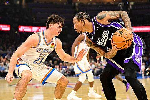 Sacramento Kings guard/forward Demar Derozan (10) looks to drive against Oklahoma City Thunder guard Brooks Barnhizer (23) during the first half of an NBA basketball game between Sacramento Kings and Oklahoma City Thunder in Oklahoma City.