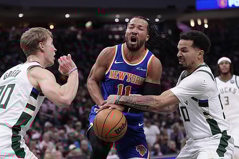 Milwaukee Bucks' Cole Anthony knocks the ball from New York Knicks' Jalen Brunson during the first half of an NBA basketball game in Milwaukee. 
