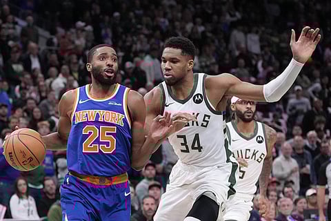 New York Knicks' Mikal Bridges tries to get past Milwaukee Bucks' Giannis Antetokounmpo during the first half of an NBA basketball game in Milwaukee. 