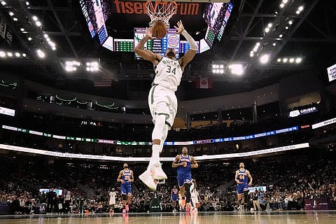 Milwaukee Bucks' Giannis Antetokounmpo dunks during the second half of an NBA basketball game against the New York Knicks in Milwaukee. 