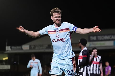 Brentford's Nathan Collins celebrates scoring during the English League Cup fourth round soccer match between Grimsby Town and Brentford in Grimsby, England.