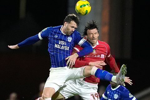 EFL Cup 2025-26, Wrexham vs Cardiff City: Wrexham's Kieffer Moore, right, and and Cardiff City's Calum Chambers battle for a head ball during the English League Cup fourth round soccer match between Wrexham and Cardiff City in Wrexham, Wales.