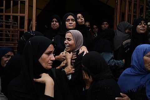 Mourners react during the funeral of their relatives killed in an Israeli army strike, at Nasser Hospital in Khan Younis, Gaza Strip, Wednesday, Oct. 29, 2025. 