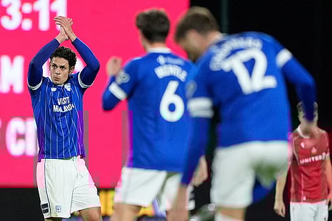 Cardiff City's Yousef Salech, left, celebrates scoring during the English League Cup fourth round soccer match between Wrexham and Cardiff City in Wrexham, Wales.