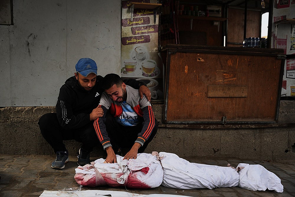 Yahya Eid mourns over the body of his 10-year-old nephew, Shabaan Eid, who was killed in an Israeli army strike on the Bureij camp, during his funeral at Al-Awda Hospital in Nuseirat, central Gaza Strip, Wednesday, Oct. 29, 2025.  - | Photo: AP/Abdel Kareem Hana