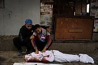 19 Days After Declaring Peace, Israel Hits Gaza With Airstrikes - In Photos | Photo: AP/Abdel Kareem Hana : Yahya Eid mourns over the body of his 10-year-old nephew, Shabaan Eid, who was killed in an Israeli army strike on the Bureij camp, during his funeral at Al-Awda Hospital in Nuseirat, central Gaza Strip, Wednesday, Oct. 29, 2025.