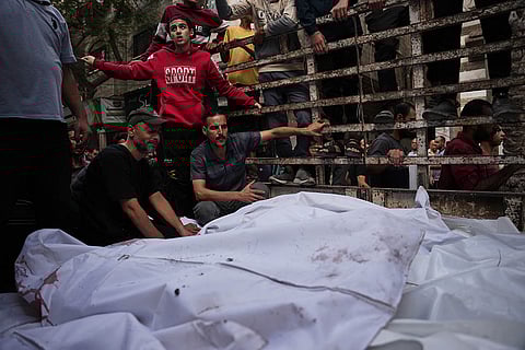 Palestinians mourn around the bodies of the Abu Dalal family killed in an Israeli military strike during their funeral at Al-Awda Hospital in Nuseirat, central Gaza Strip, Wednesday, Oct. 29, 2025.