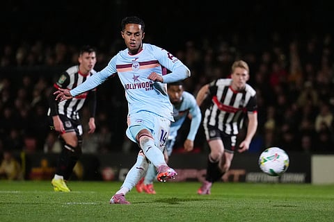 Brentford's Fabio Carvalho scores from the penalty spot for their fourth goal of the game against Grimsby during a League Cup fourth round soccer match Grimsby, England.