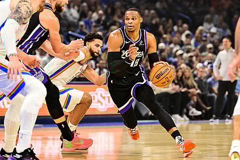 Sacramento Kings guard Russell Westbrook (18) drives the ball against Oklahoma City Thunder guard Ajay Mitchell (25) during the first half of an NBA basketball game between Sacramento Kings and Oklahoma City Thunder in Oklahoma City. 