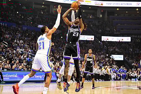 Sacramento Kings guard Keon Ellis (23) drives against Oklahoma City Thunder guard Aaron Wiggins (21) during the first half of an NBA basketball game between Sacramento Kings and Oklahoma City Thunder in Oklahoma City. 