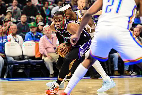 Sacramento Kings guard Russell Westbrook (18) drives against Oklahoma City Thunder guard Shai Gilgeous-Alexander (2) during the first half of an NBA basketball game between Sacramento Kings and Oklahoma City Thunder in Oklahoma City. 