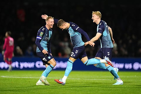 Wycombe Wanderers' Cauley Woodrow, center, celebrates scoring during the English League Cup fourth round soccer match between Wycombe Wanderers and Fulham, in High Wycombe, England.