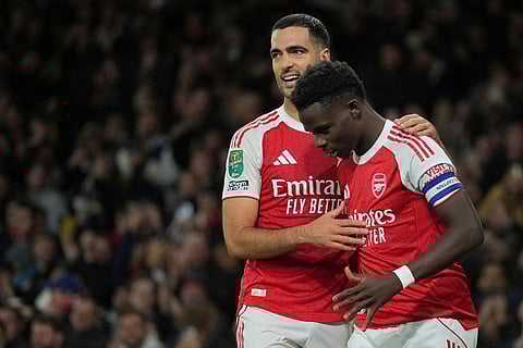 Arsenal vs Brighton & Hove Albion: Arsenal's Bukayo Saka, right, celebrates after scoring his side's second goal during the English League Cup soccer match between Arsenal and Brighton & Hove Albion in London.