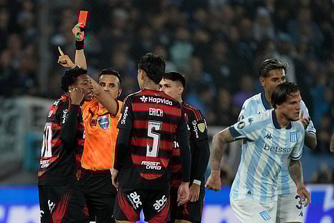 Referee Piero Maza sends Gonzalo Plata, left, of Brazil's Flamengo off during a Copa Libertadores semifinal second leg soccer match against Argentina's Racing Club in Buenos Aires, Argentina.
