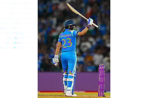 India's captain Harmanpreet Kaur celebrates her half century during an ICC Women's World Cup semifinal ODI cricket match between India Women and Australia Women, at the DY Patil Stadium, in Navi Mumbai.