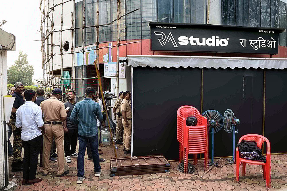 | Photo: PTI : Police personnel at the site where 19 persons including 17 children were rescued from a studio in Powai area while the man who had held them hostage succumbed to bullet injuries sustained during the operation, in Mumbai.