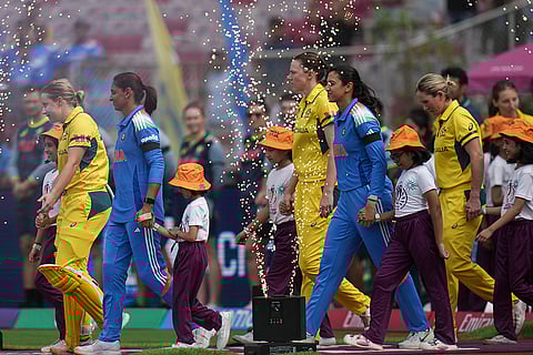 India's captain Harmanpreet Kaur and Australia's captain Alyssa Healy arrive on the ground with their teammates before an ICC Women's World Cup semifinal ODI cricket match between India Women and Australia Women, at the DY Patil Stadium, in Navi Mumbai.