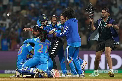 India's players celebrate after winning the ICC Women's Cricket World Cup cricket semi final against Australia in Navi Mumbai.
