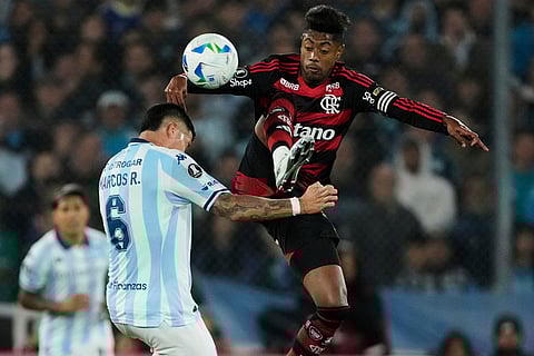 Bruno Henrique of Brazil's Flamengo, right, and Marcos Rojo of Argentina's Racing Club fight for the ball during a Copa Libertadores semifinal second leg soccer match in Buenos Aires, Argentina.