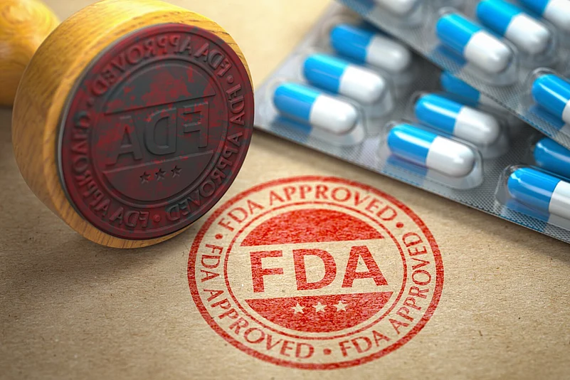 USFDA approval stamp with pharma drugs next to it