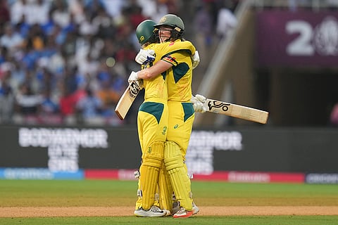 Australia's Phoebe Litchfield celebrates her century with Ellyse Perry during an ICC Women's World Cup semifinal ODI cricket match between India Women and Australia Women, at the DY Patil Stadium, in Navi Mumbai.