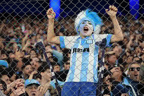 A fan of Argentina's Racing Club cheers prior to a Copa Libertadores semifinal second leg soccer match against Brazil's Flamengo in Buenos Aires, Argentina.